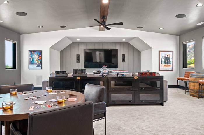 Upstairs media and game room with theater wall